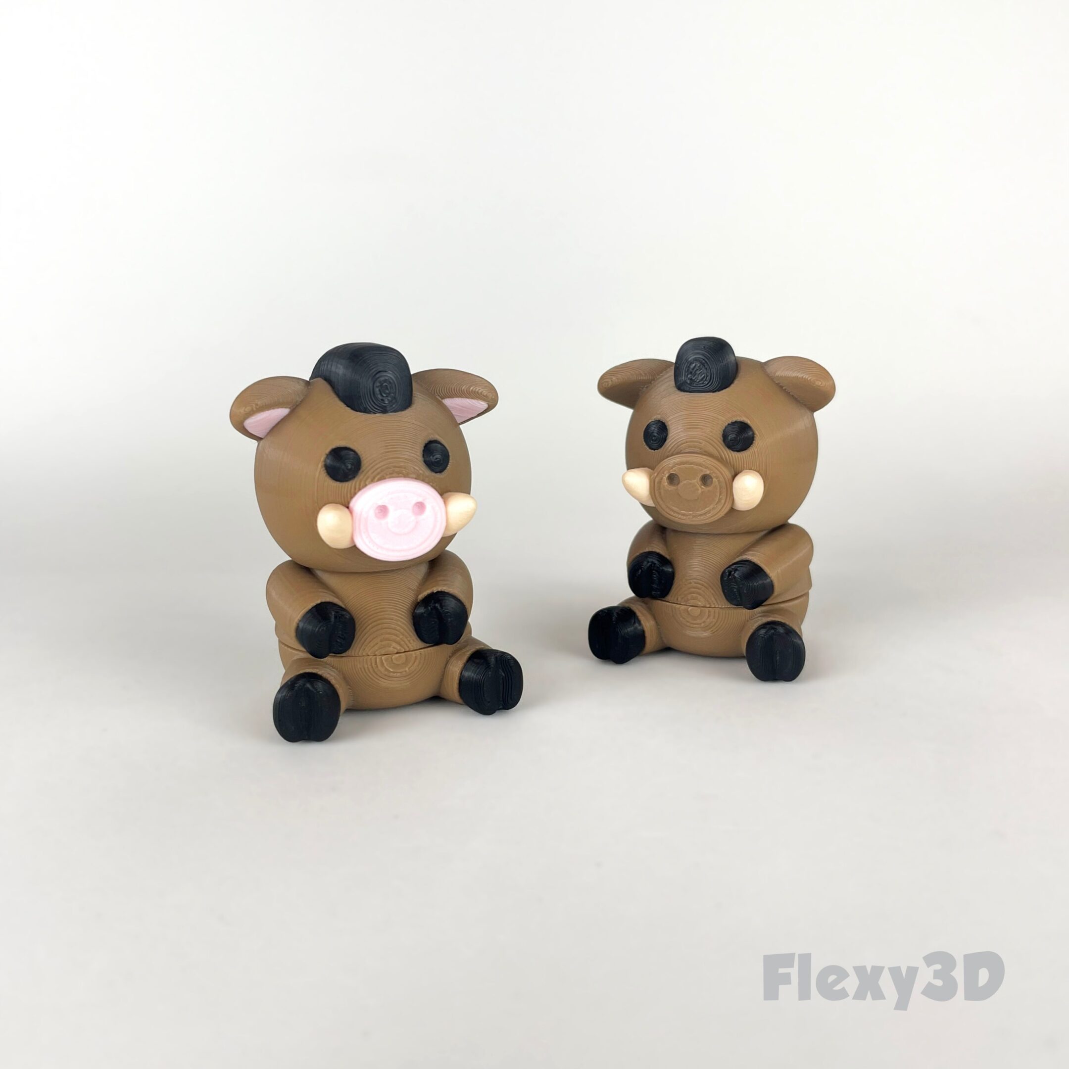 Two small, cute cow figurines made of clay with black spots and pink noses.
