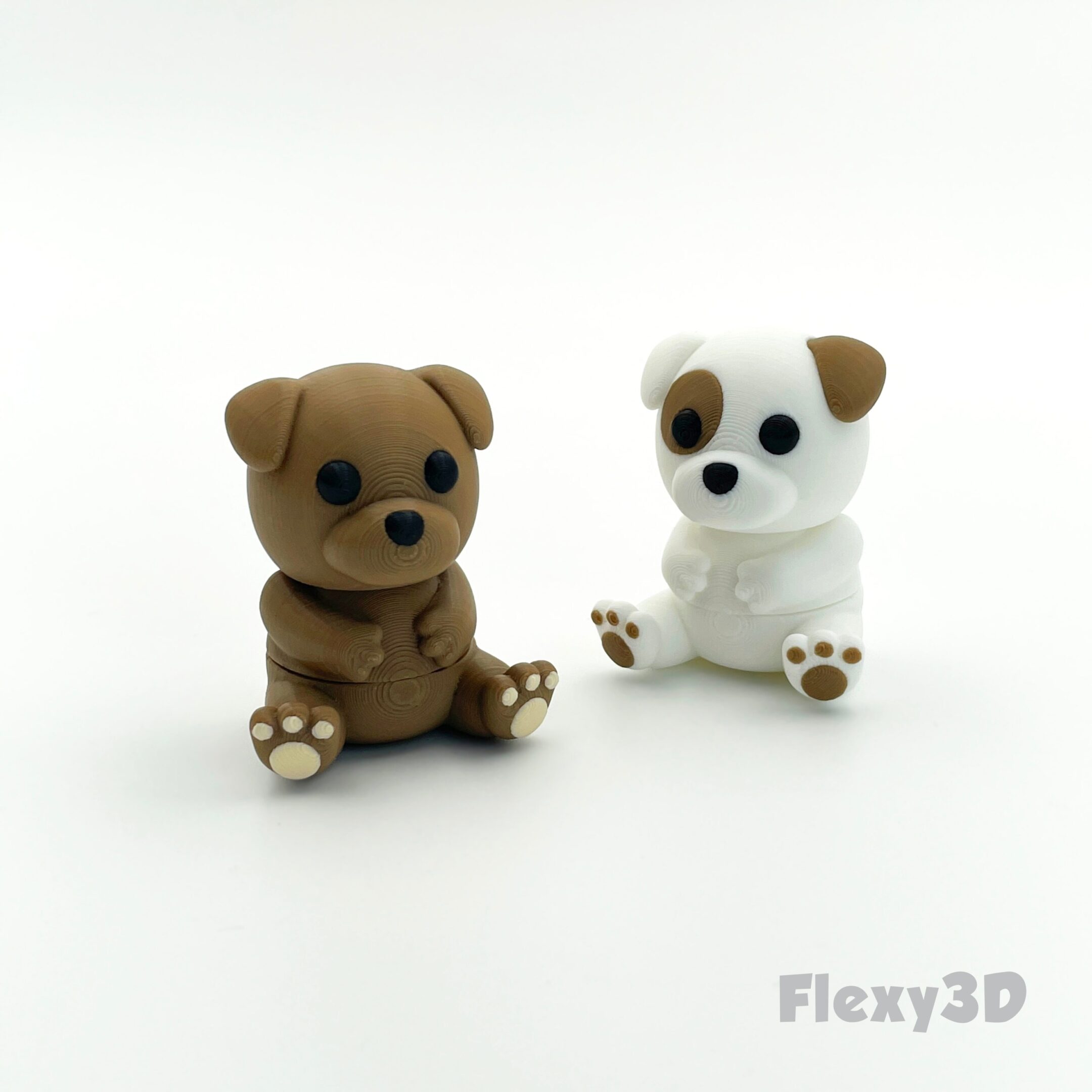 Two small, cute dog figurines with expressive eyes on a white background.