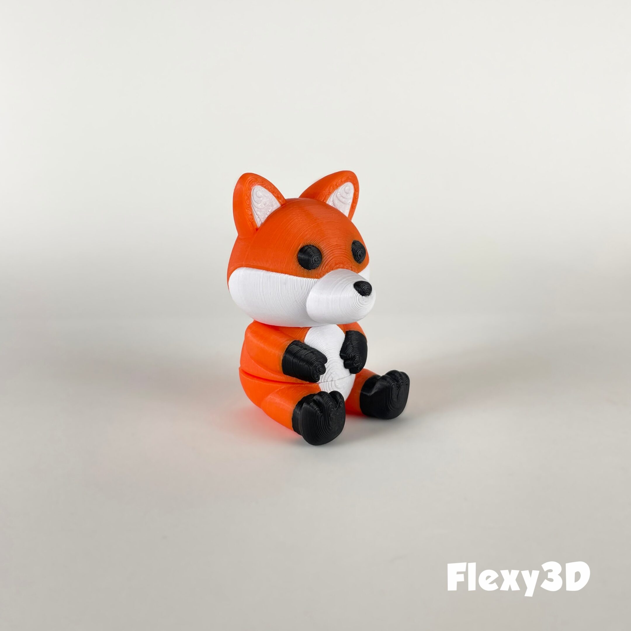 A cute 3D-printed fox figurine sitting upright.