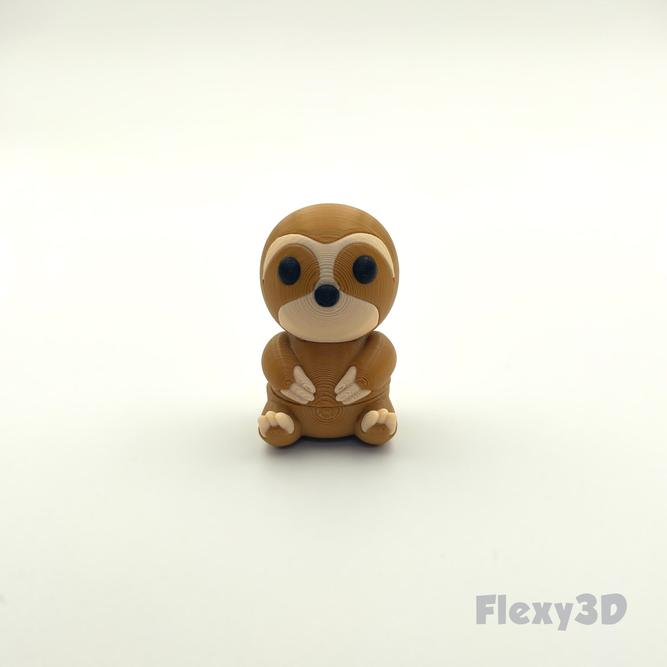 A small, cute meerkat figurine with big eyes on a plain white background.