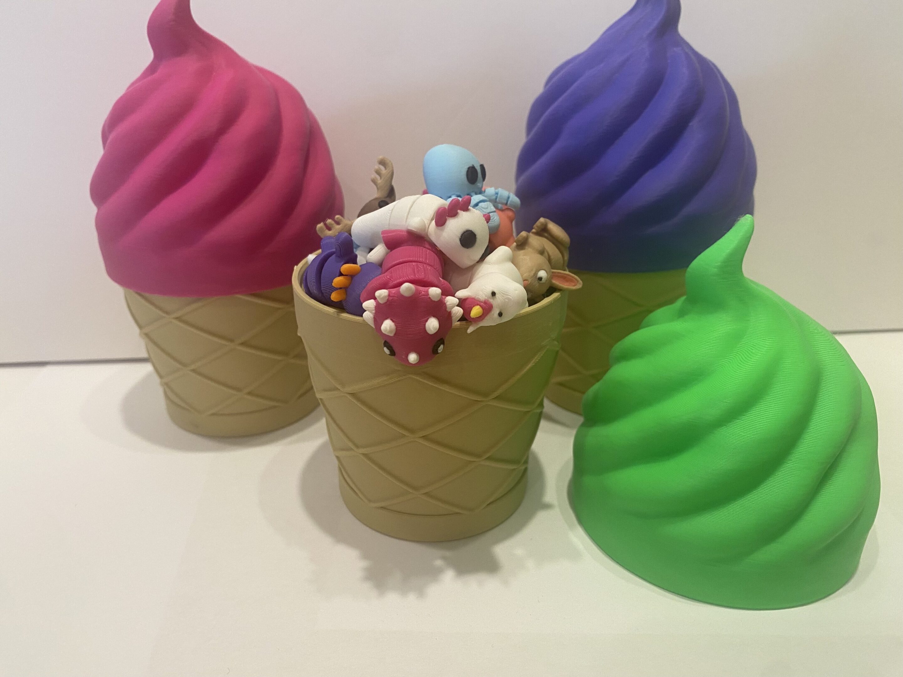 Colorful ice cream cone toys with cute animal figures inside one cone.