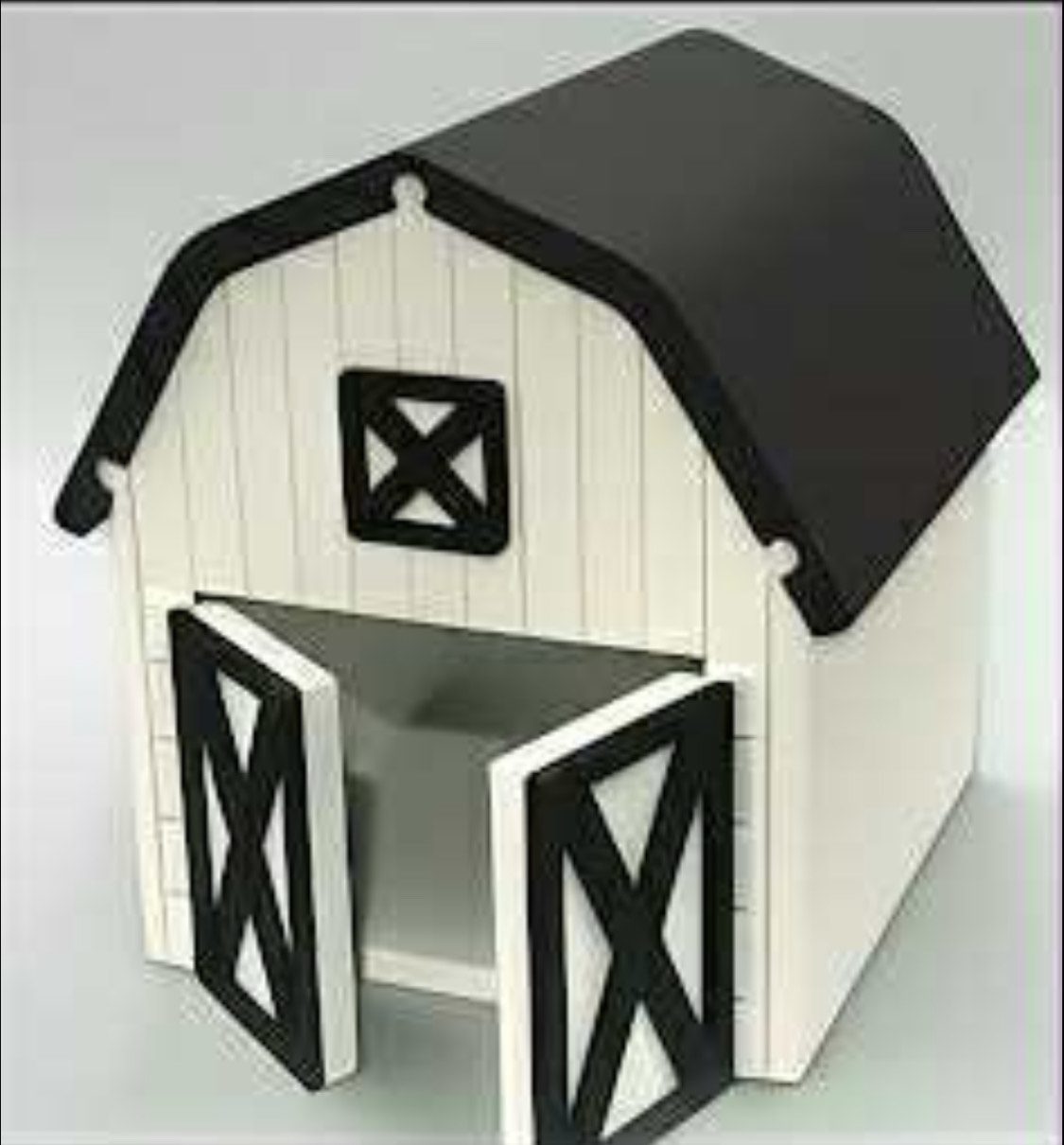 A small white and black barn model with open double doors.