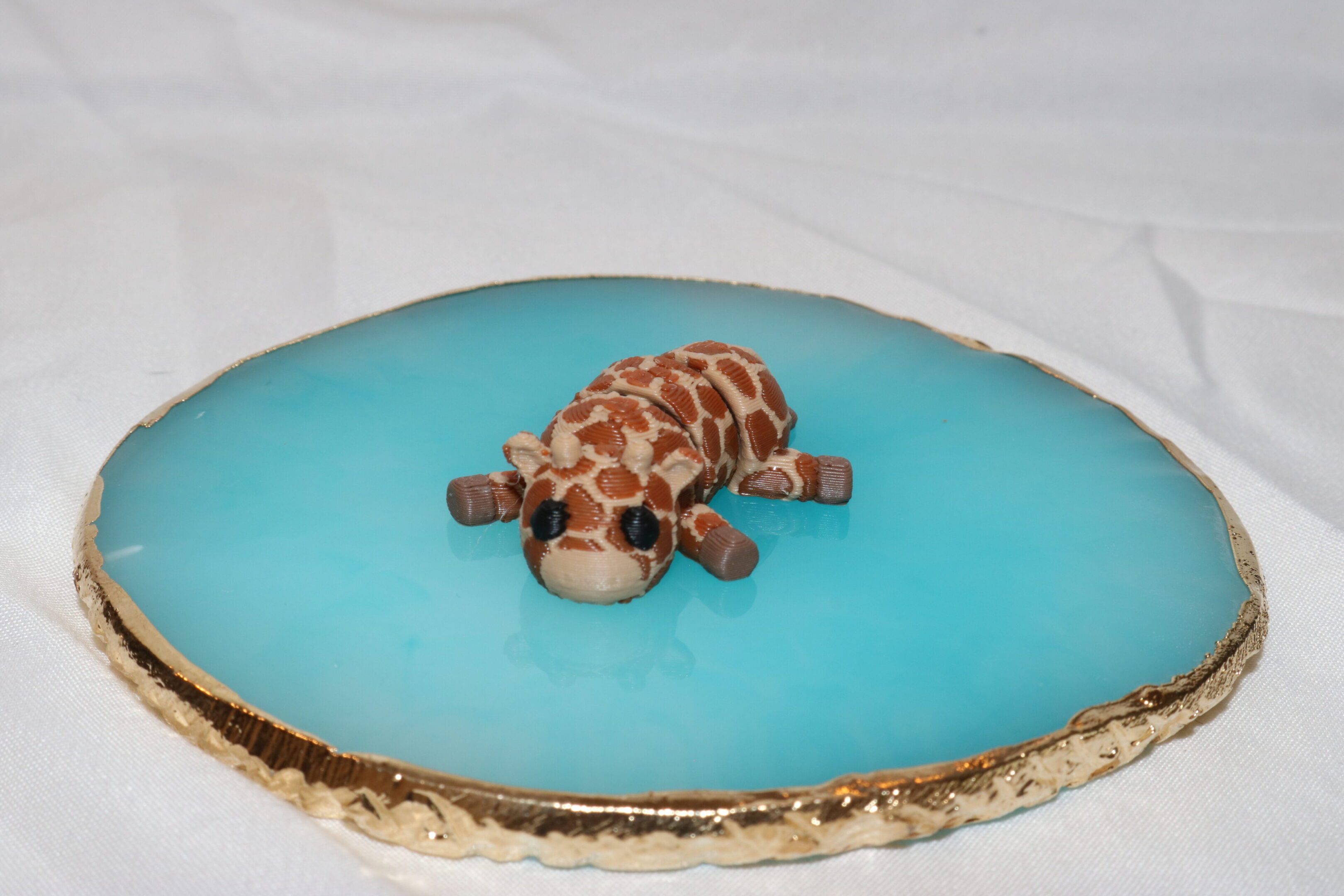 A small turtle figurine on a blue geode slice.