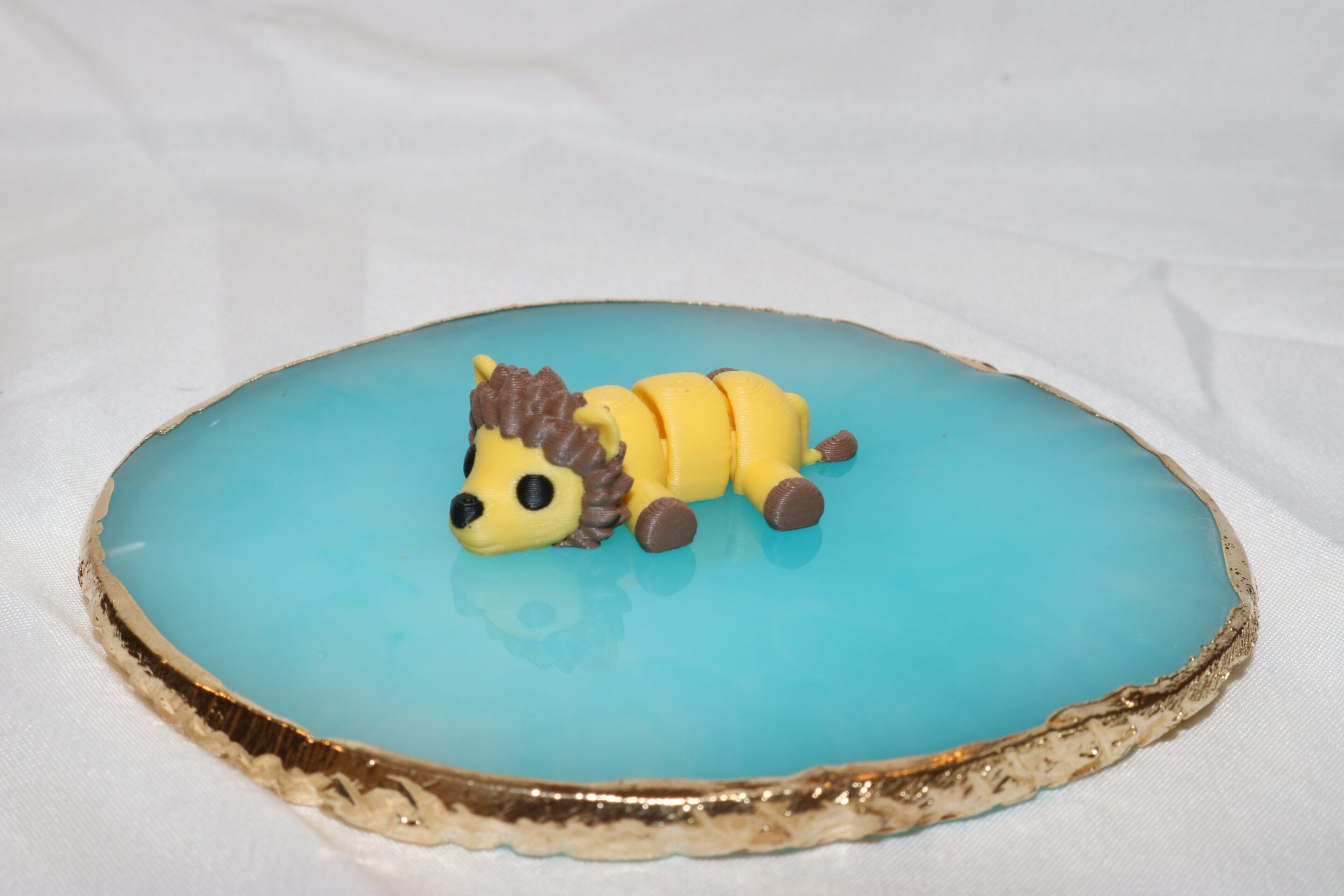 A dessert with a caterpillar-shaped decoration on a blue surface.