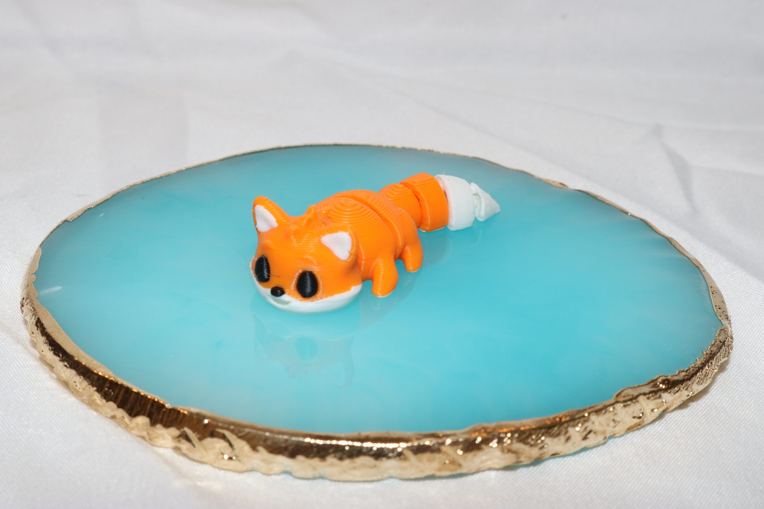 A dessert shaped like a swimming clownfish on blue icing.