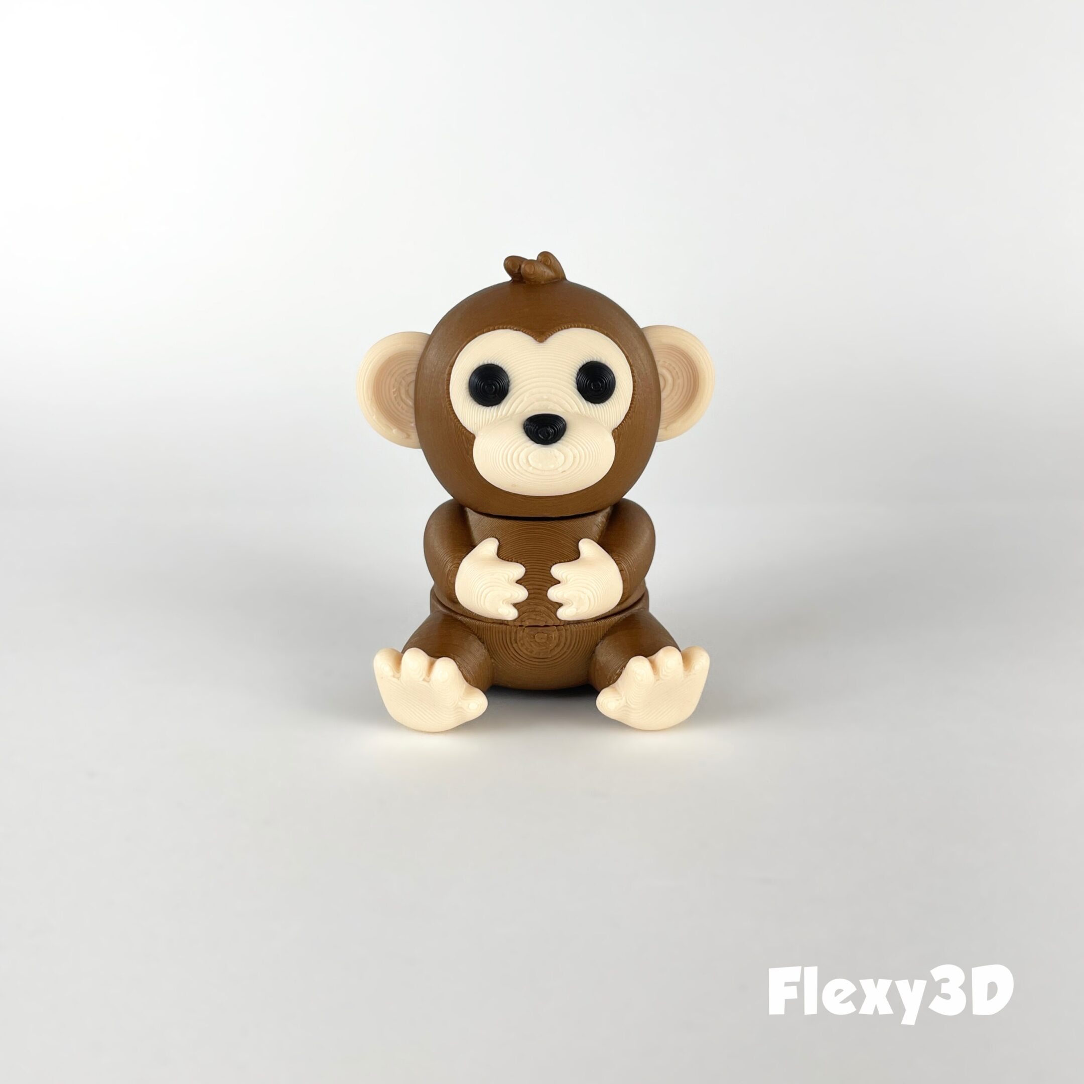 Cute brown monkey figurine with big eyes and a friendly smile.