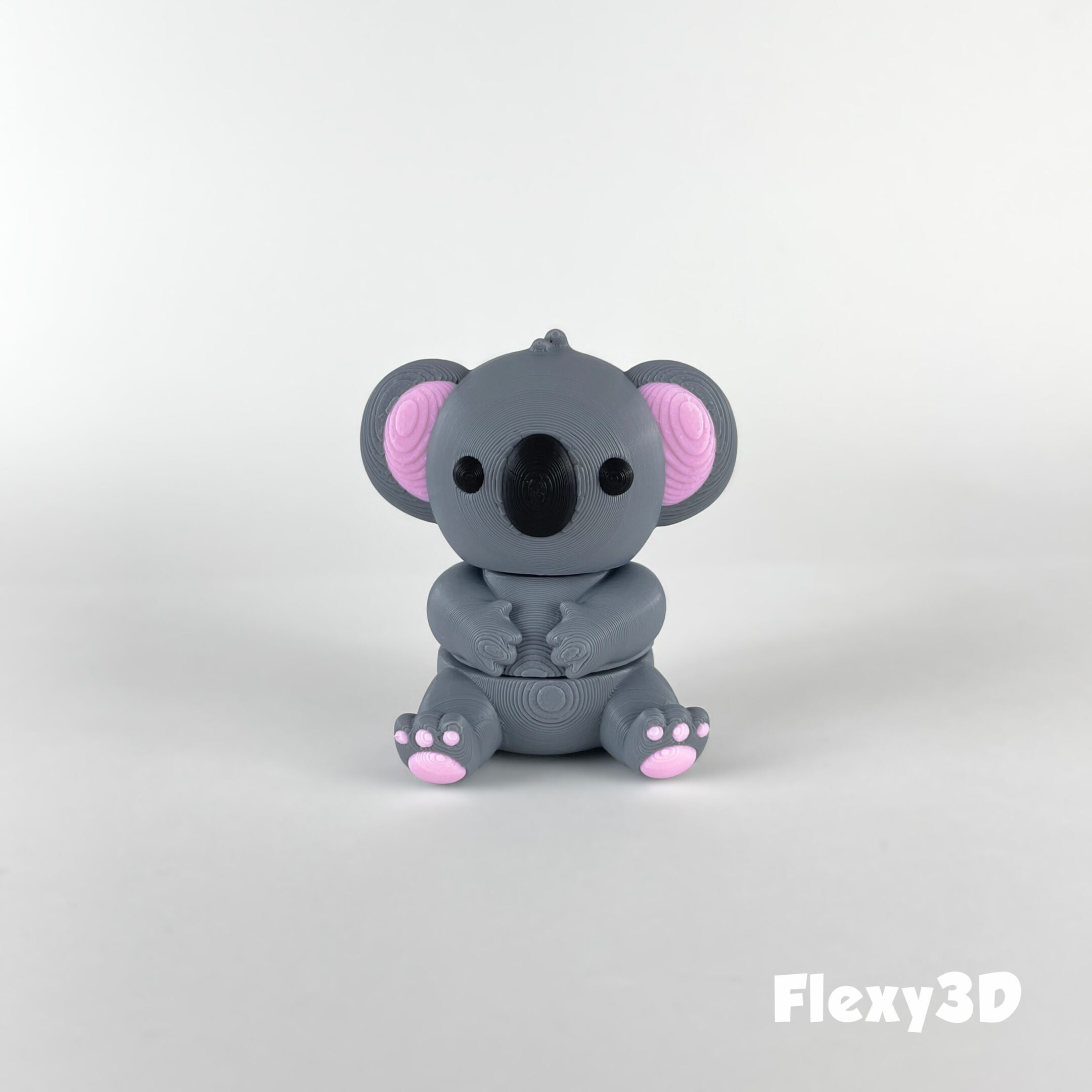 Cute gray koala figurine with pink ears and feet on white background.