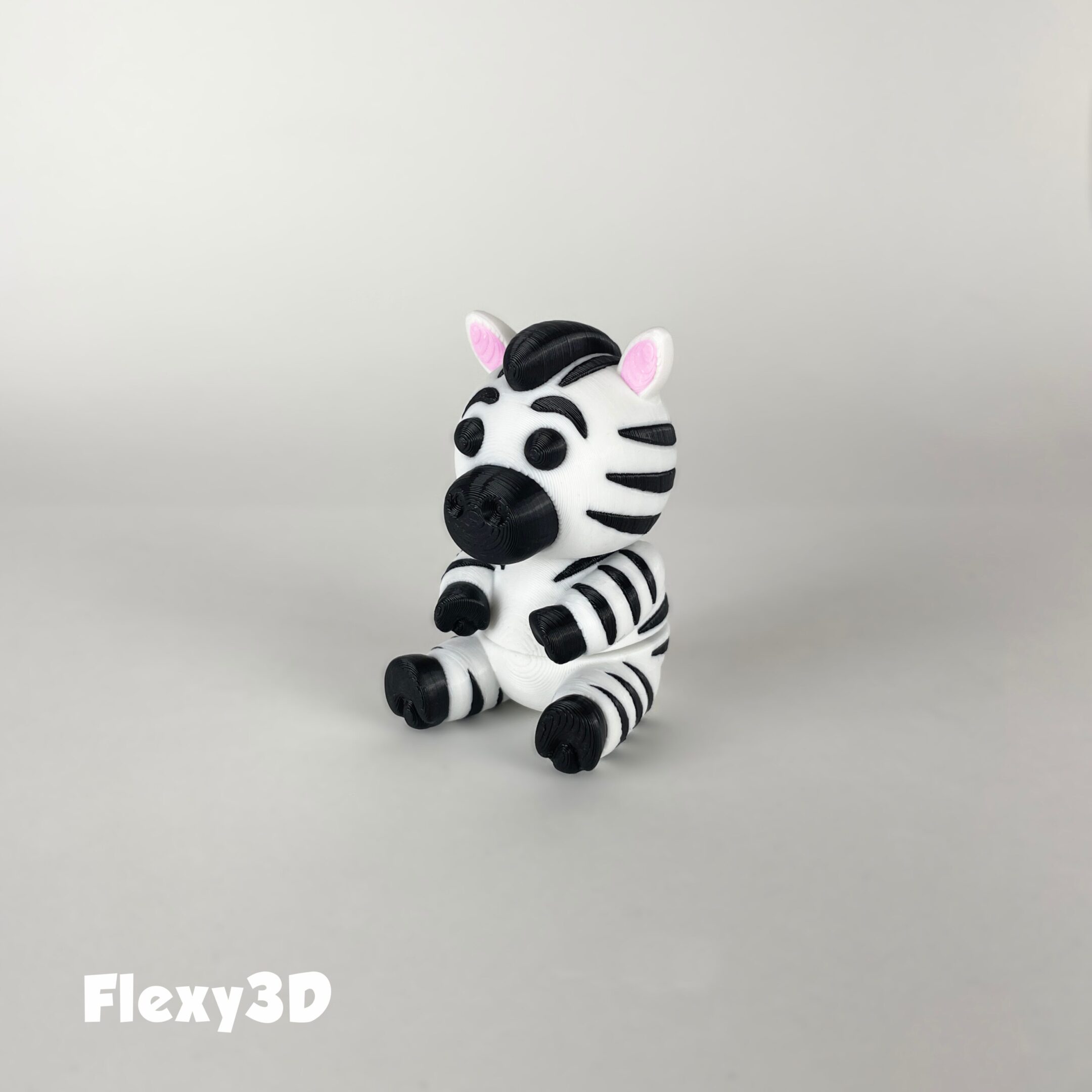 A cute 3D-printed zebra figurine with black and white stripes.