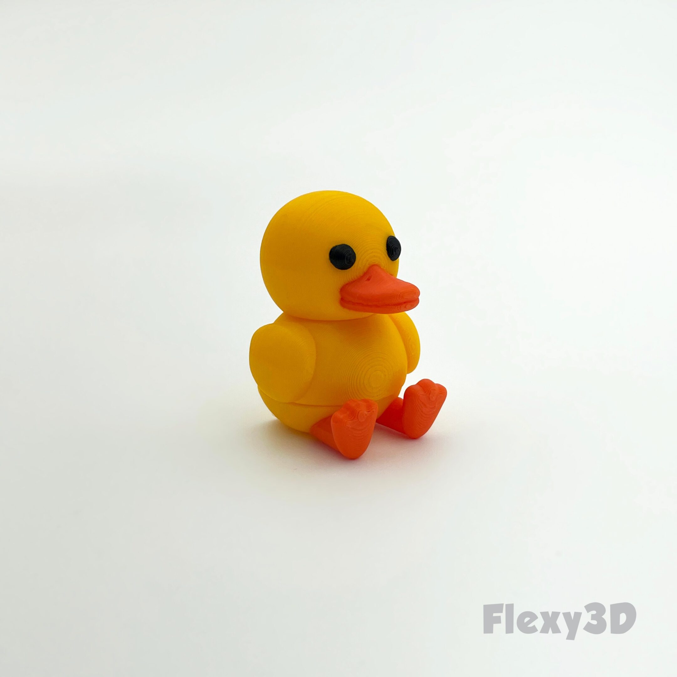 A small yellow rubber duck with orange beak and feet.